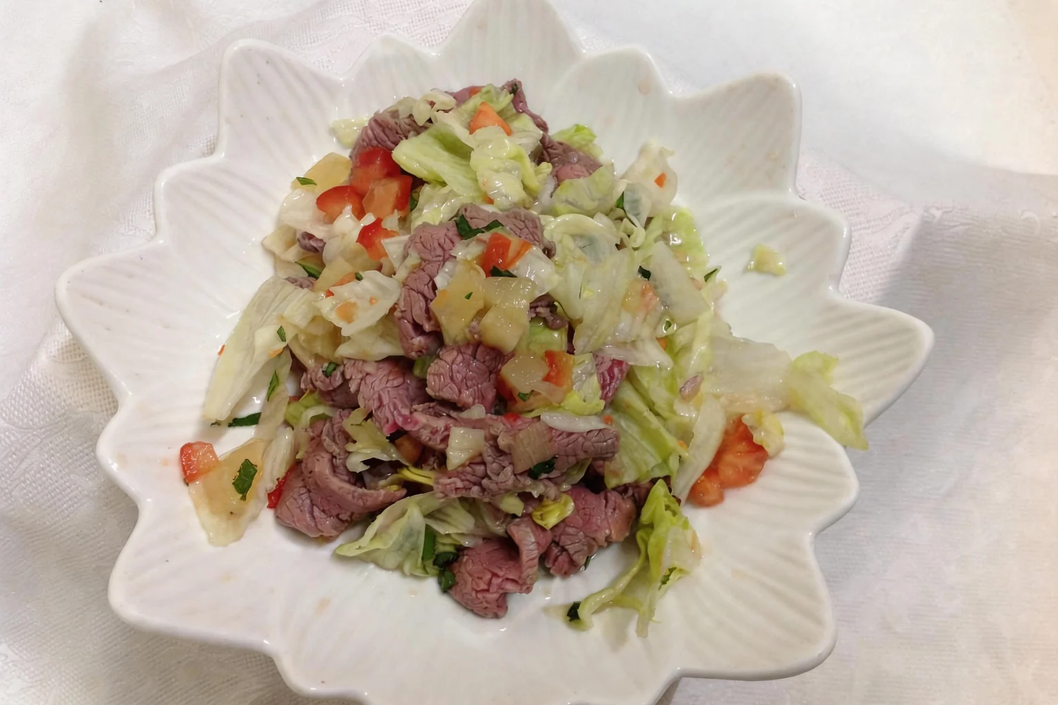 Salad in a white flower-shaped bowl